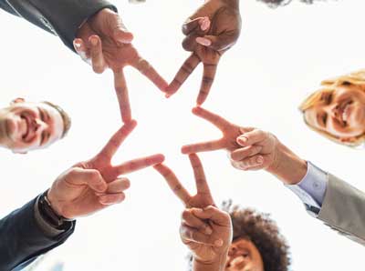 group of people forming hand star